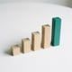 Physical bar chart of wooden blocks — symbolizing data-driven space decisions with hot desking