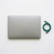Laptop with teal charging cable — symbolizing flexible hybrid work with hot desking