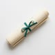 Rolled architectural blueprint with teal ribbon — symbolizing smart space planning with a hot desking solution